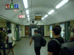Between the two platforms. The display is indicating (by way of an arrow) which platform each of the next trains will depart from