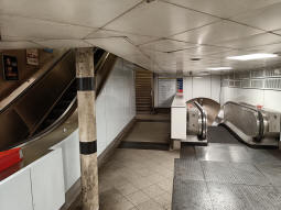 Escalator up to the ticket hall on the left, stairs up to the District and Circle line eastbound platform in the centre, the escalator up from the Northern line northbound platform on the right