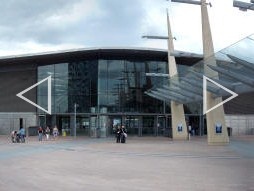 Auto-stitched panoramic photo of the station building, with the canopies on the left and right over the bus station (June 2009)