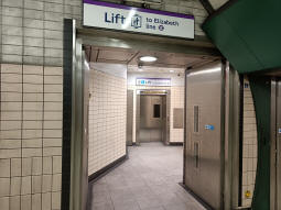The lift to the tunnel to the Elizabeth line from between the Bakerloo line platforms. The stairs and escalators to the exit and the District and Circle lines are behind the camera