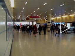 Panorama at new northern ticket hall with exit on left; lift, escalators and stairs to central and east subways centre-left; and lift, escalators and stairs to west subway to right (automatically stitched together from eight photos, hence "ghosts")