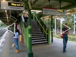 Stairs up to the footbridge from the westbound platforms